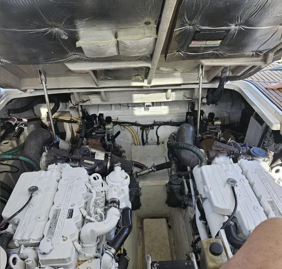Marcello Yacht Photos Pics Engine compartment of a 2008 Sea Ray Sundancer boat, showcasing dual engines and mechanical components.