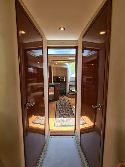 Marcello Yacht Photos Pics Interior hallway of 2008 Sea Ray Sundancer yacht, featuring polished wood doors and elegant decor.