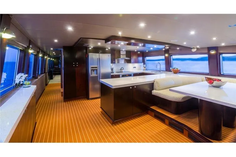 Unbridled Yacht Photos Pics Luxurious Crescent 116 yacht interior, featuring modern kitchen and dining area, 1995 model.