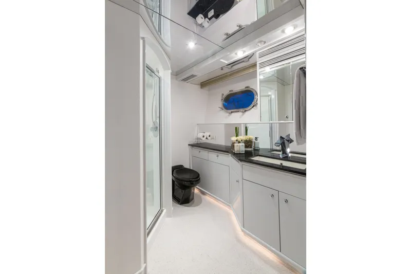 Unbridled Yacht Photos Pics Luxurious yacht bathroom with modern fixtures, black toilet, and sleek cabinetry, Crescent 116, 1995.