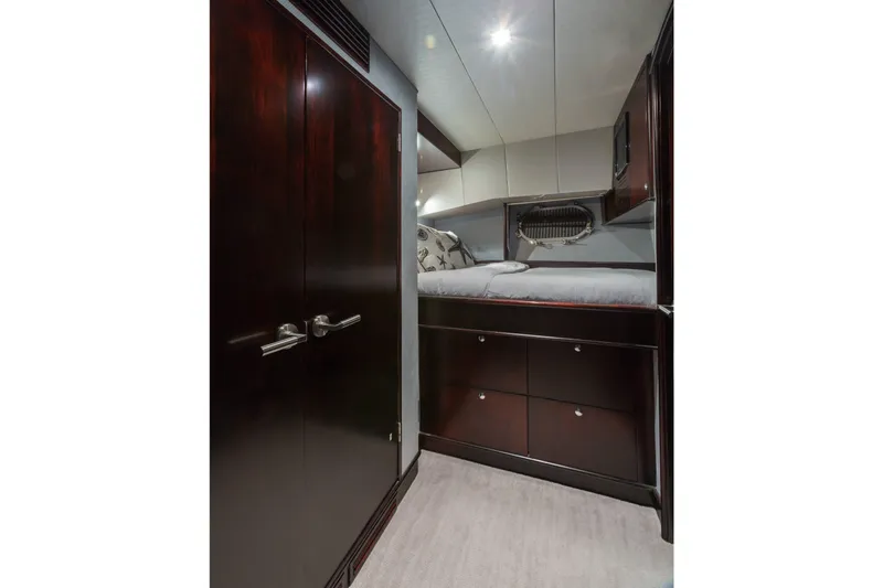 Unbridled Yacht Photos Pics Luxurious cabin interior of 1995 Crescent 116 yacht with dark wood finishes.