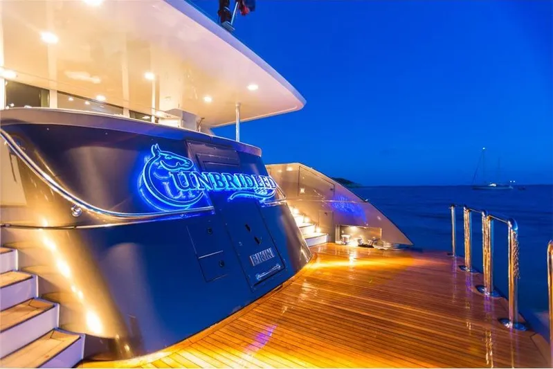 Unbridled Yacht Photos Pics Luxurious Crescent 116 yacht "Unbridled" with illuminated deck at sunset, 1995 model.