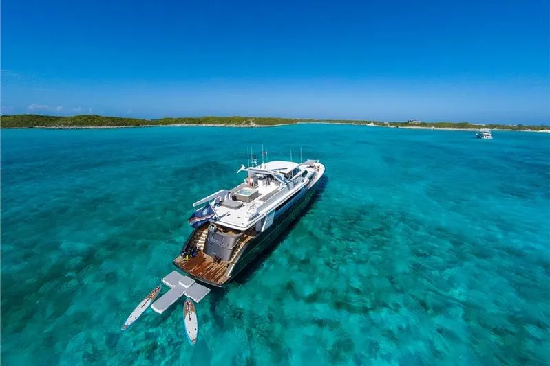 Unbridled Yacht Photos Pics Luxury yacht Crescent 116 (1995) cruising in clear turquoise waters.