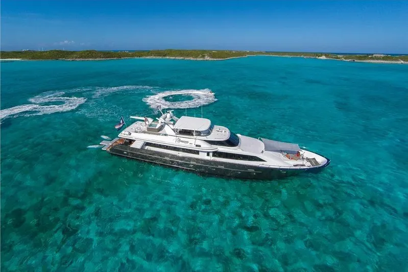 Unbridled Yacht Photos Pics Luxurious 1995 Crescent 116 yacht cruising in clear turquoise waters.