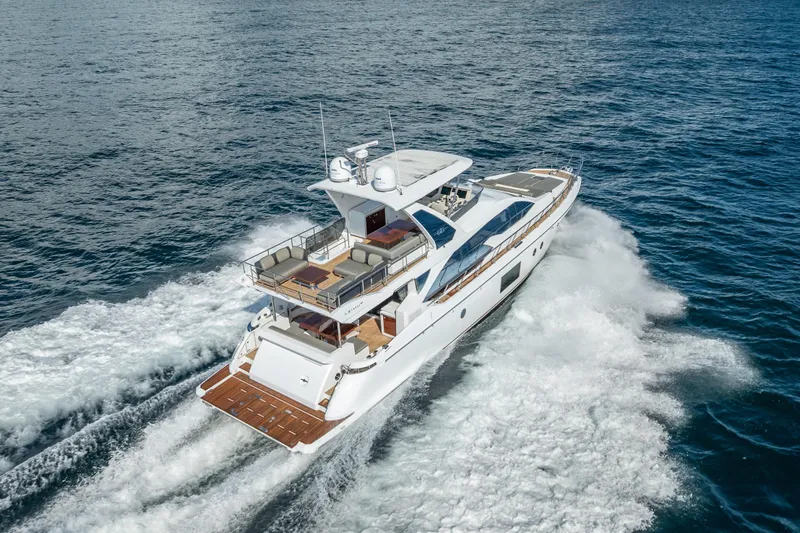  Yacht Photos Pics Luxurious 2019 Azimut 66 yacht cruising on open sea, showcasing elegant design and spacious deck.