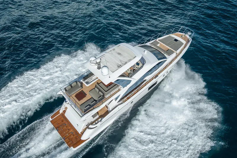  Yacht Photos Pics Luxurious 2019 Azimut 66 yacht cruising on open sea, aerial view.