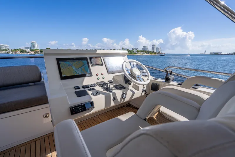  Yacht Photos Pics Luxurious 2019 Azimut 66 yacht helm with navigation screens, steering wheel, and ocean view.