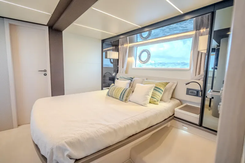  Yacht Photos Pics Luxurious bedroom interior of 2019 Azimut 66 yacht with modern design and ocean view.