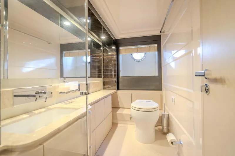  Yacht Photos Pics Luxurious bathroom interior of 2019 Azimut 66 yacht, featuring modern fixtures and elegant design.