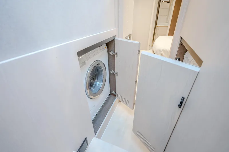  Yacht Photos Pics Laundry area with washing machine in 2019 Azimut 66 yacht interior.
