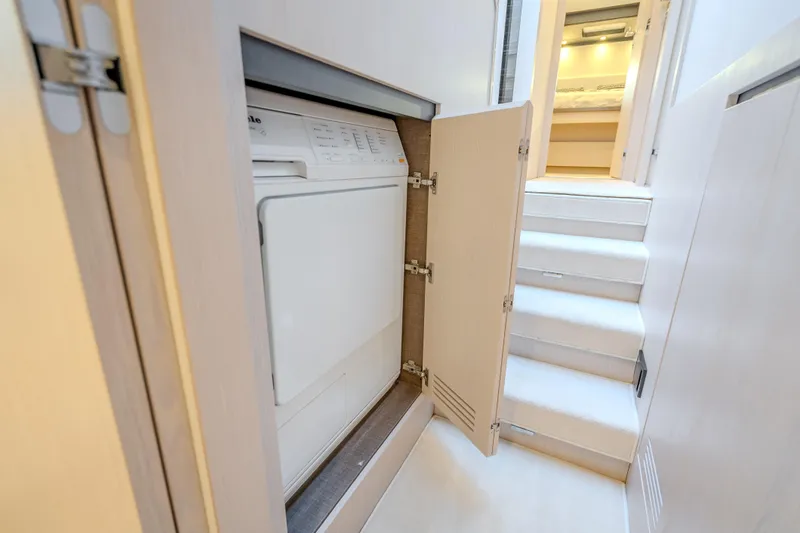  Yacht Photos Pics Laundry area in 2019 Azimut 66 yacht with washer and stairs leading to cabin.