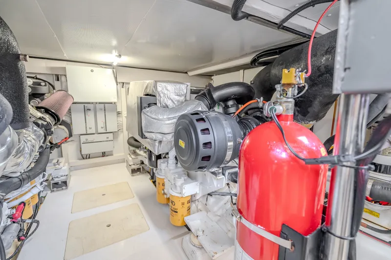  Yacht Photos Pics Engine room of 2019 Azimut 66 yacht, featuring machinery and fire extinguisher.