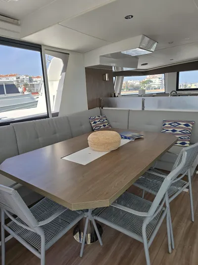 Catacha Yacht Photos Pics Interior of 2022 Bali 4.6 yacht with modern dining area and large windows.