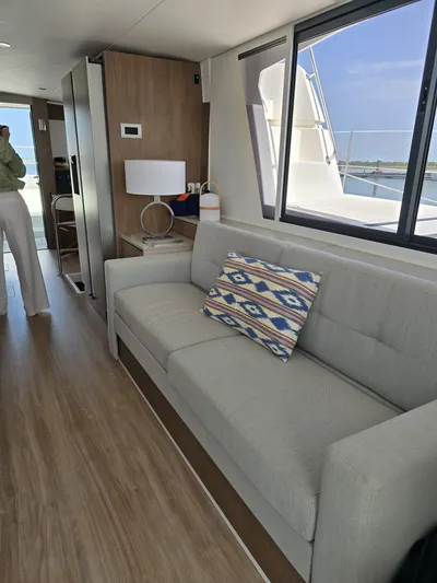 Catacha Yacht Photos Pics Modern interior of 2022 Bali 4.6 yacht with sofa and decorative pillow.