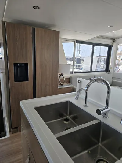 Catacha Yacht Photos Pics Modern kitchen interior on 2022 Bali 4.6 yacht with dual sinks and large windows.