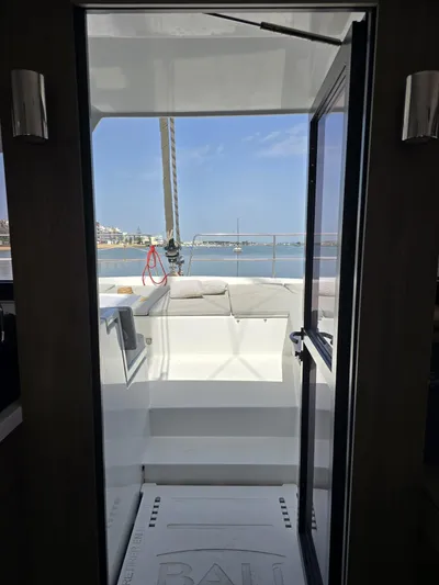 Catacha Yacht Photos Pics View from inside a 2022 Bali 4.6 yacht, overlooking a sunny marina.