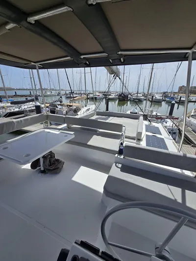 Catacha Yacht Photos Pics Spacious deck of 2022 Bali 4.6 yacht docked at marina with sailboats.