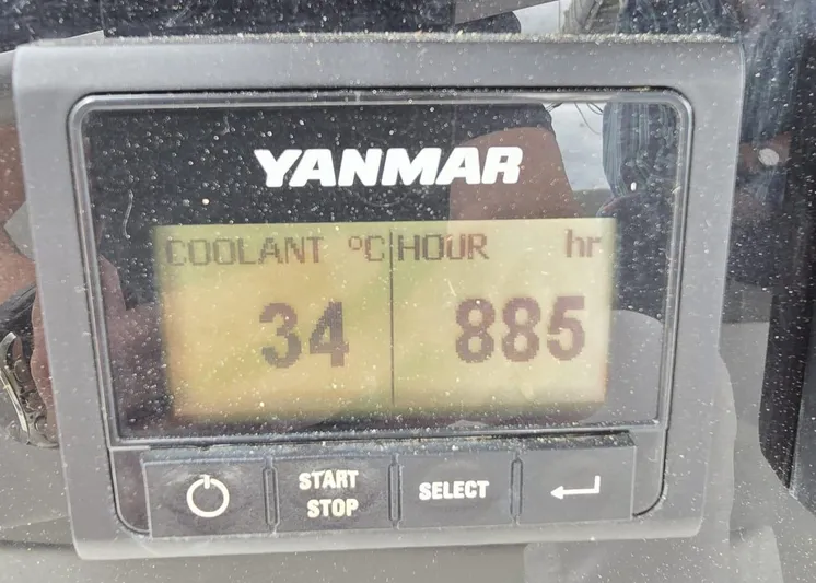 Catacha Yacht Photos Pics Yanmar engine display showing coolant temperature 34°C and 885 hours of operation.