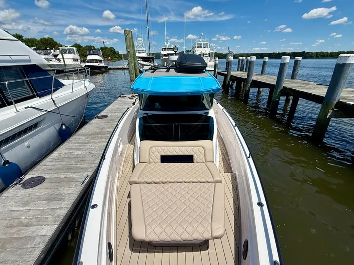 Good Vibes Yacht Photos Pics 2023 Axopar 37 Cross Cabin docked at marina under blue sky.