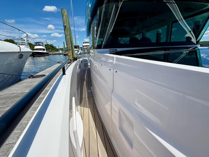 Good Vibes Yacht Photos Pics 2023 Axopar 37 Cross Cabin docked, showcasing sleek design and modern features.