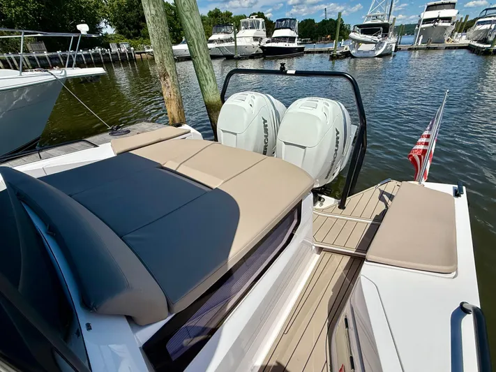 Good Vibes Yacht Photos Pics 2023 Axopar 37 Cross Cabin boat with twin Mercury engines docked at a marina.