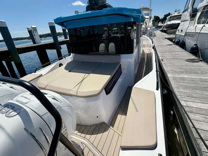 Good Vibes Yacht Photos Pics 2023 Axopar 37 Cross Cabin boat docked, featuring sleek design and spacious deck.