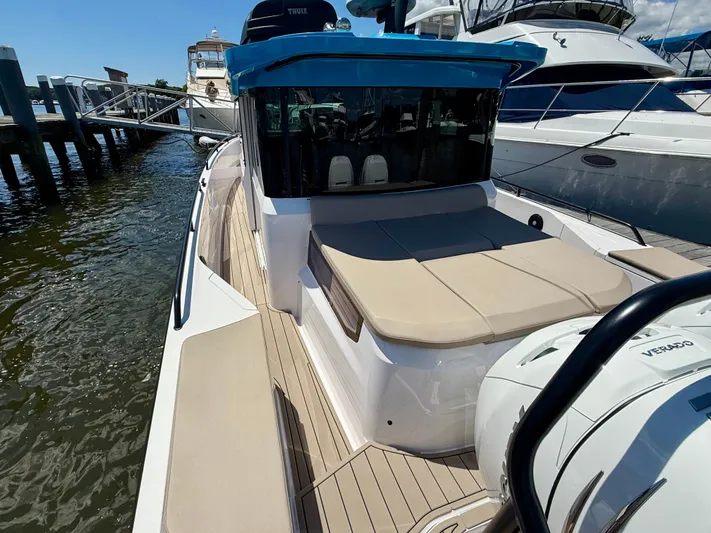 Good Vibes Yacht Photos Pics 2023 Axopar 37 Cross Cabin boat docked, featuring sleek design and spacious deck.