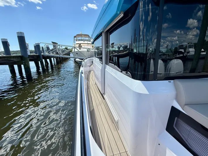 Good Vibes Yacht Photos Pics 2023 Axopar 37 Cross Cabin docked, showcasing sleek design and modern features.