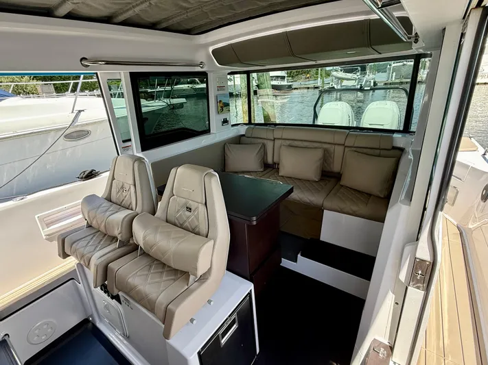 Good Vibes Yacht Photos Pics 2023 Axopar 37 Cross Cabin interior with plush seating and modern design.