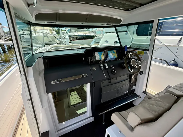 Good Vibes Yacht Photos Pics Interior of 2023 Axopar 37 Cross Cabin boat with modern helm and navigation screens.