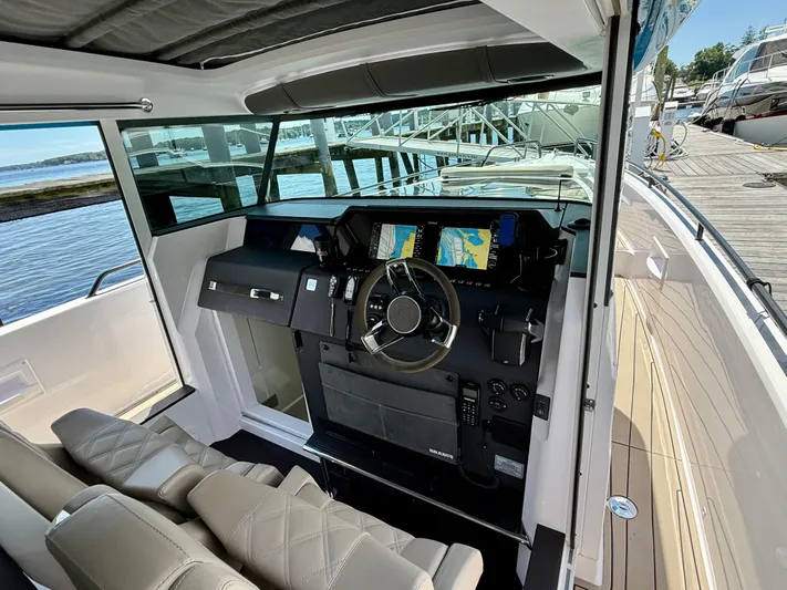 Good Vibes Yacht Photos Pics 2023 Axopar 37 Cross Cabin interior with modern dashboard and navigation screens.