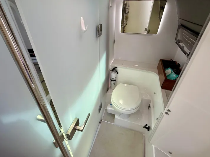 Good Vibes Yacht Photos Pics 2023 Axopar 37 Cross Cabin bathroom interior with toilet and mirror.