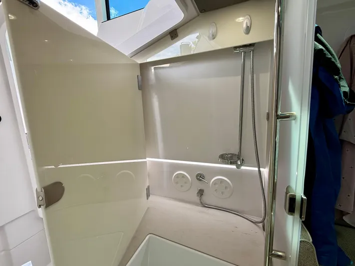Good Vibes Yacht Photos Pics 2023 Axopar 37 Cross Cabin bathroom with shower and modern fixtures.