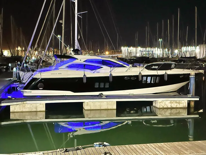  Yacht Photos Pics Luxury Absolute 56 yacht docked at night, illuminated with blue lights, 2008 model.