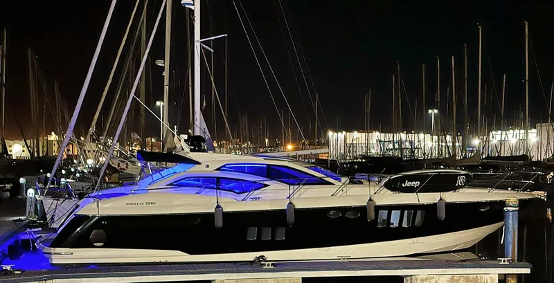  Yacht Photos Pics Luxury Absolute 56 yacht docked at night, illuminated with blue lights, 2008 model.