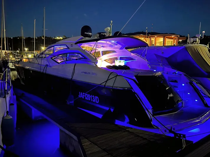  Yacht Photos Pics Luxury Absolute 56 yacht docked at night, illuminated by blue lights, 2008 model.