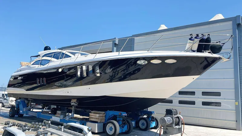  Yacht Photos Pics Luxury Absolute 56 yacht from 2008 on a trailer, parked near a modern building.