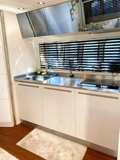  Yacht Photos Pics Modern kitchen in a 2008 Absolute 56 yacht with sleek cabinetry and stainless steel appliances.