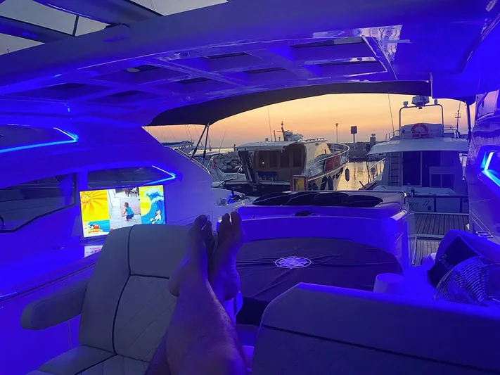  Yacht Photos Pics Luxurious Absolute 56 yacht interior with blue lighting, sunset view, and a relaxing atmosphere.