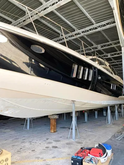  Yacht Photos Pics 2008 Absolute 56 yacht in storage, sleek black hull, elevated on supports.