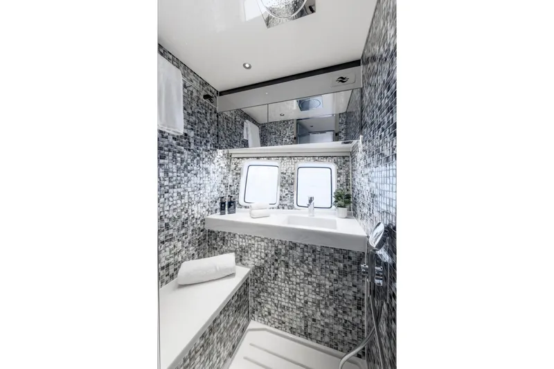 Baateaux Yacht Photos Pics Luxurious 2024 Zeelander 5 yacht bathroom with modern mosaic tiles and sleek fixtures.
