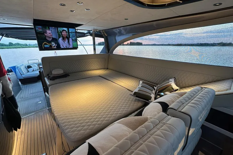 Baateaux Yacht Photos Pics Luxurious interior of 2024 Zeelander 5 yacht with plush seating and scenic water view.