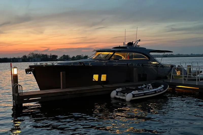 Baateaux Yacht Photos Pics 2024 Zeelander 5 yacht docked at sunset, with a serene waterfront view.