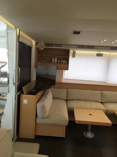  Yacht Photos Pics Luxurious interior of 2015 Lagoon 560 S2 yacht with modern seating and entertainment area.
