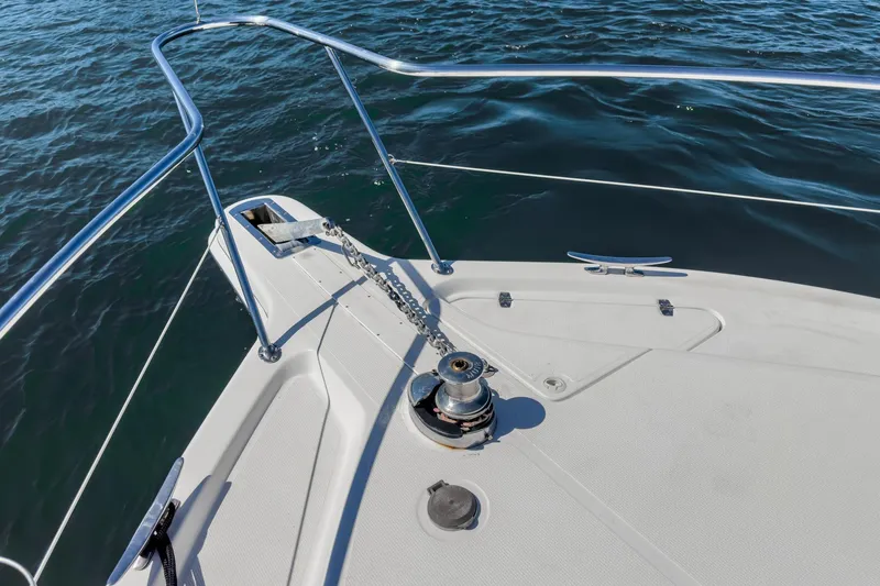 Lil' Breezy Yacht Photos Pics Bow of 2006 Riviera 33 Flybridge yacht with anchor chain and railing.