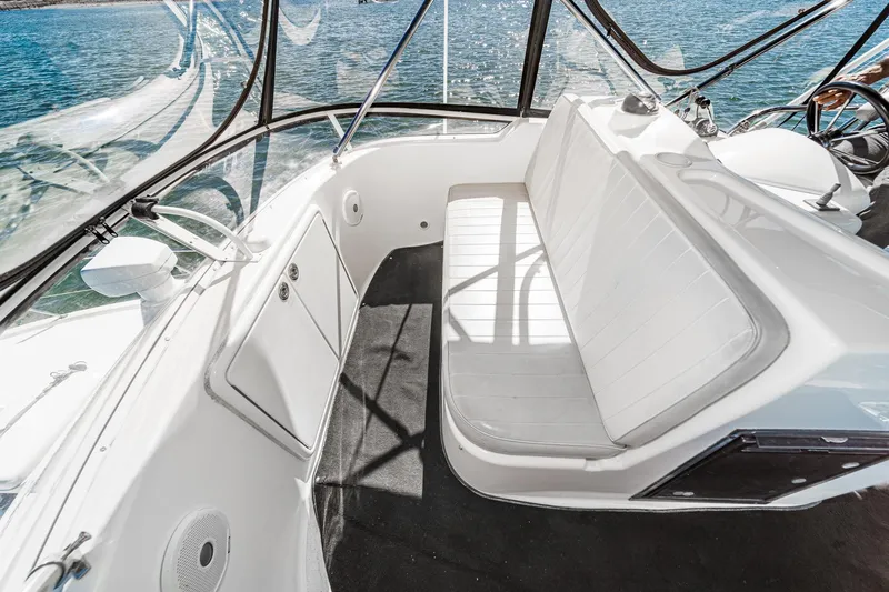 Lil' Breezy Yacht Photos Pics 2006 Riviera 33 Flybridge interior with white seating and panoramic windows.