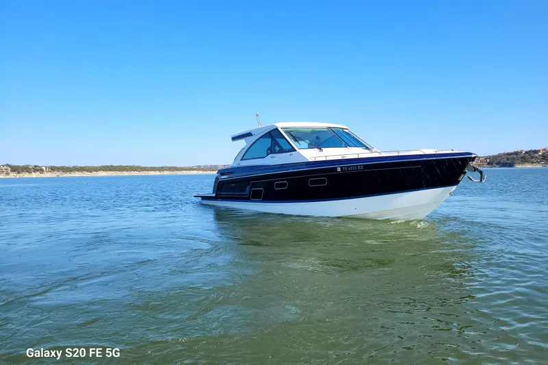 Master Plan Yacht Photos Pics 2023 Formula 380 Super Sport Crossover I/O boat cruising on a sunny lake.