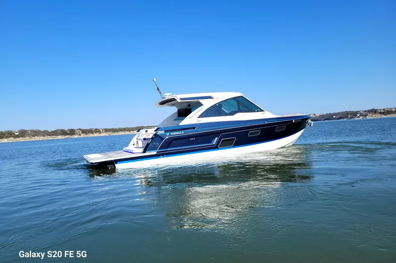 Master Plan Yacht Photos Pics 2023 Formula 380 Super Sport Crossover I/O boat cruising on a calm lake.