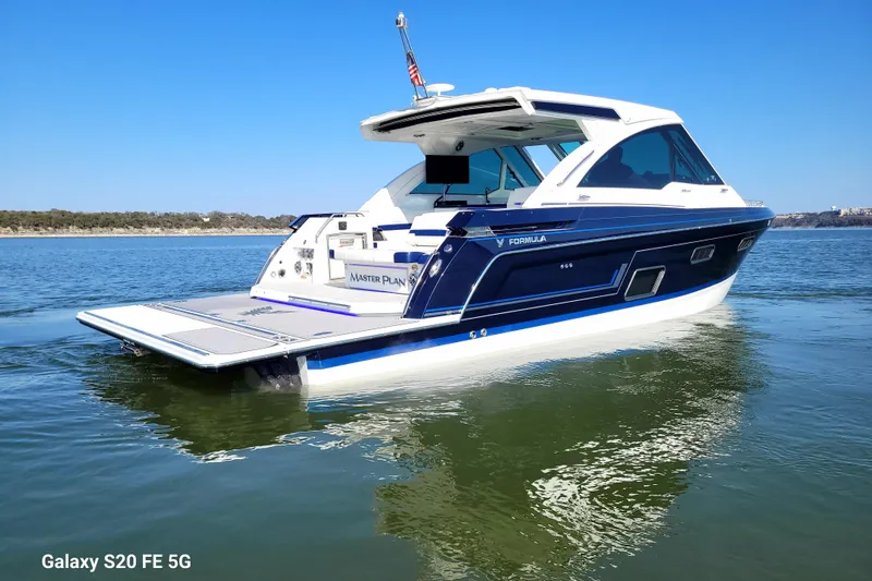 Master Plan Yacht Photos Pics 2023 Formula 380 Super Sport Crossover I/O boat on calm water, showcasing sleek design.