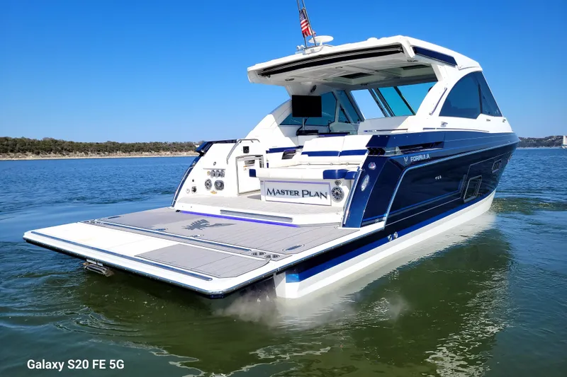 Master Plan Yacht Photos Pics 2023 Formula 380 Super Sport Crossover I/O boat on calm water, rear view.